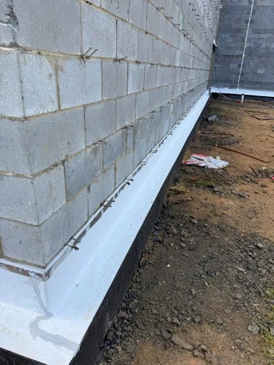 CMU Block wall under construction with eye wire and non-asphaltic GENFLASH flashing